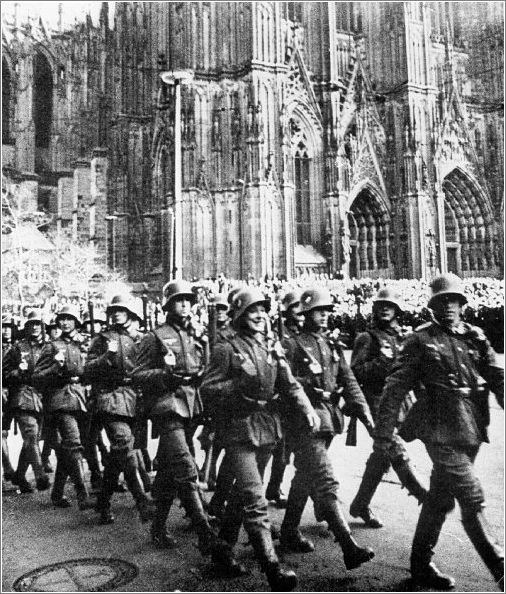 A parade of German soldiers marching past St. Stephen's Cathedral in Vienna, upon the annexation of Austria to the Reich